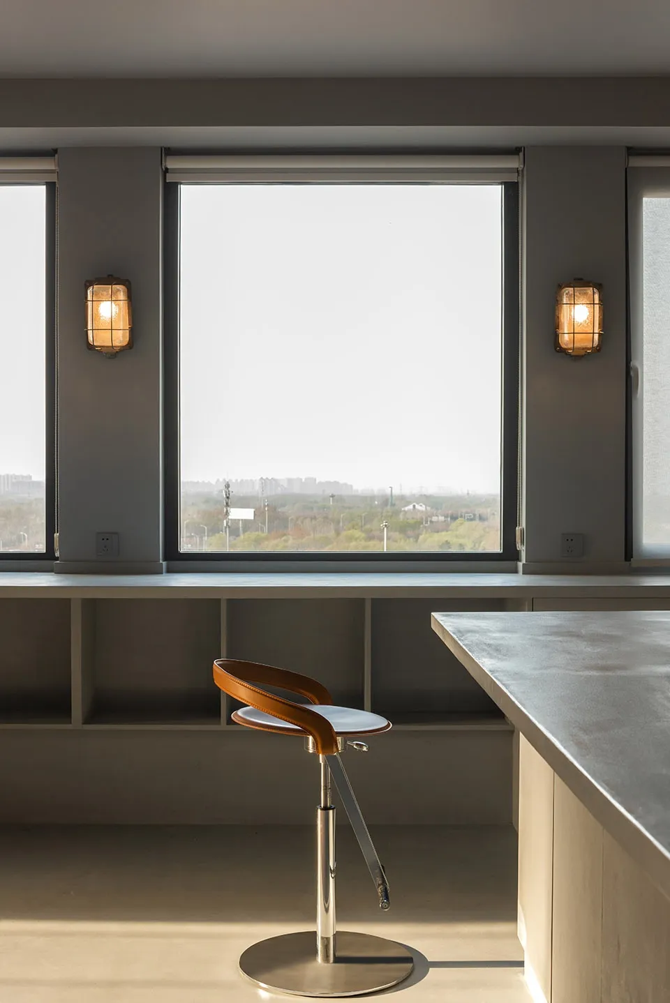 A modern kitchen with a concrete countertop and minimalist design.
