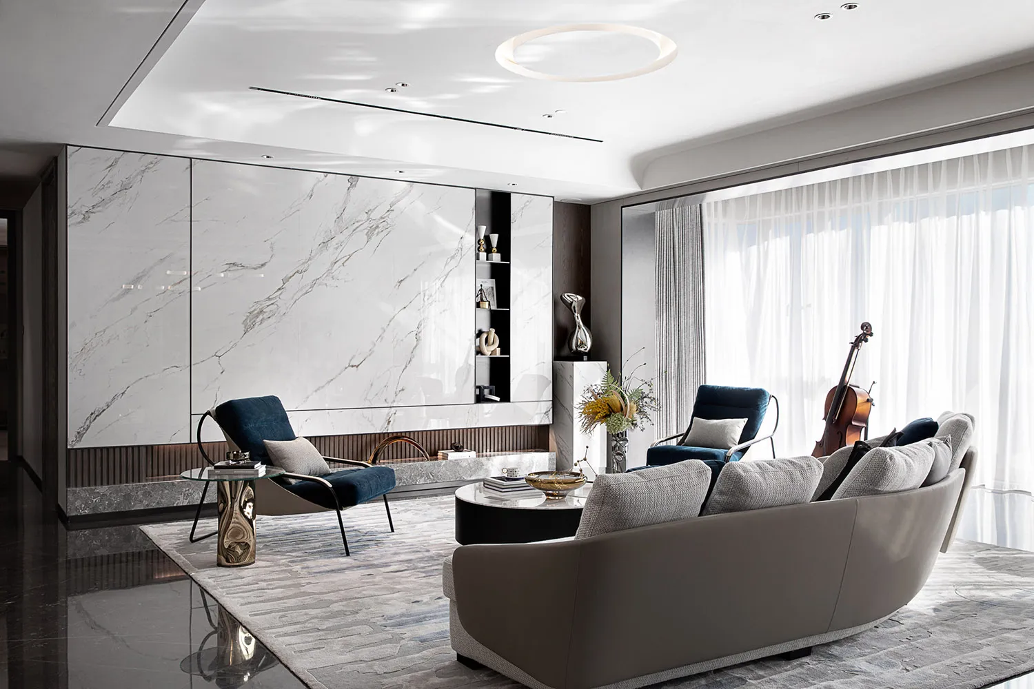 Modern living room featuring marble walls, leather furniture, and glass decor.
