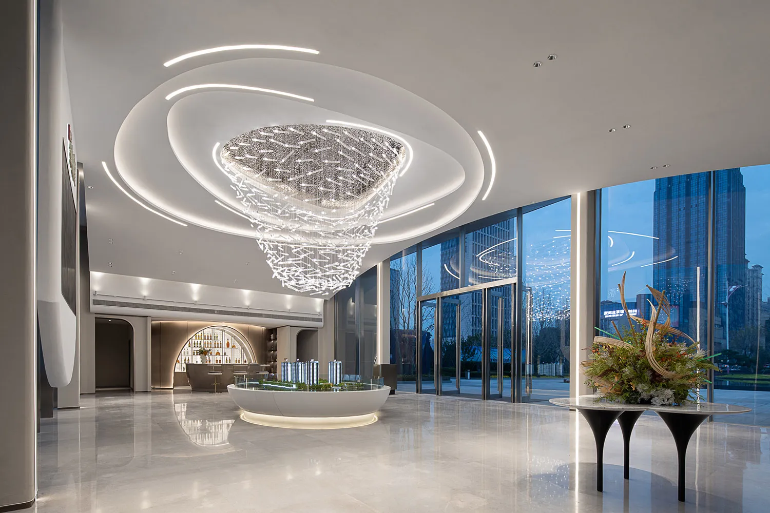Modern lobby interior with glass chandelier and sleek, minimalist design