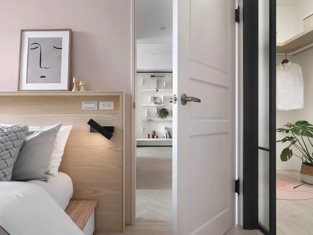 Modern minimalist bedroom featuring wood accents and laminate flooring