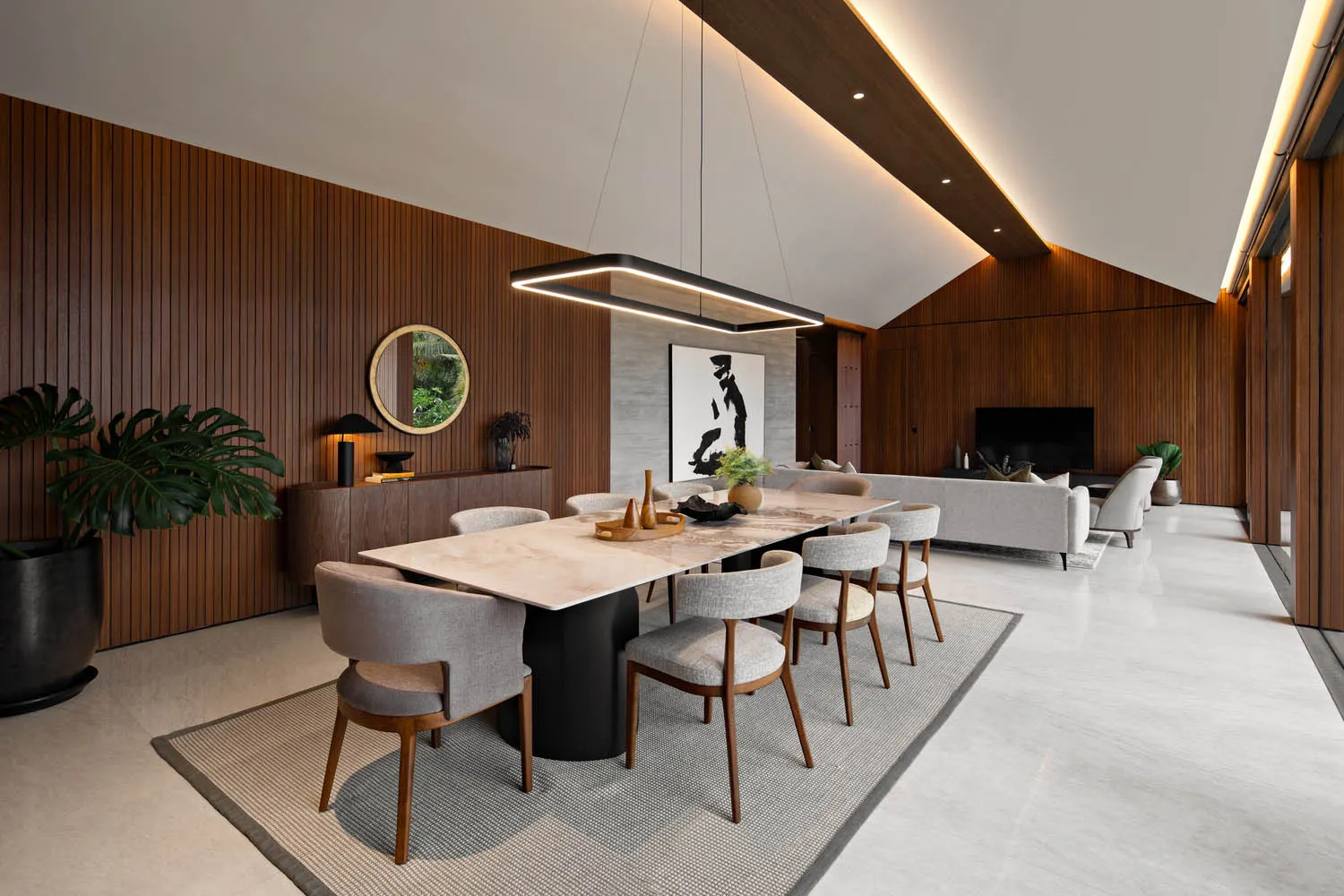 A modern residential interior featuring wood, marble, and fabric materials.