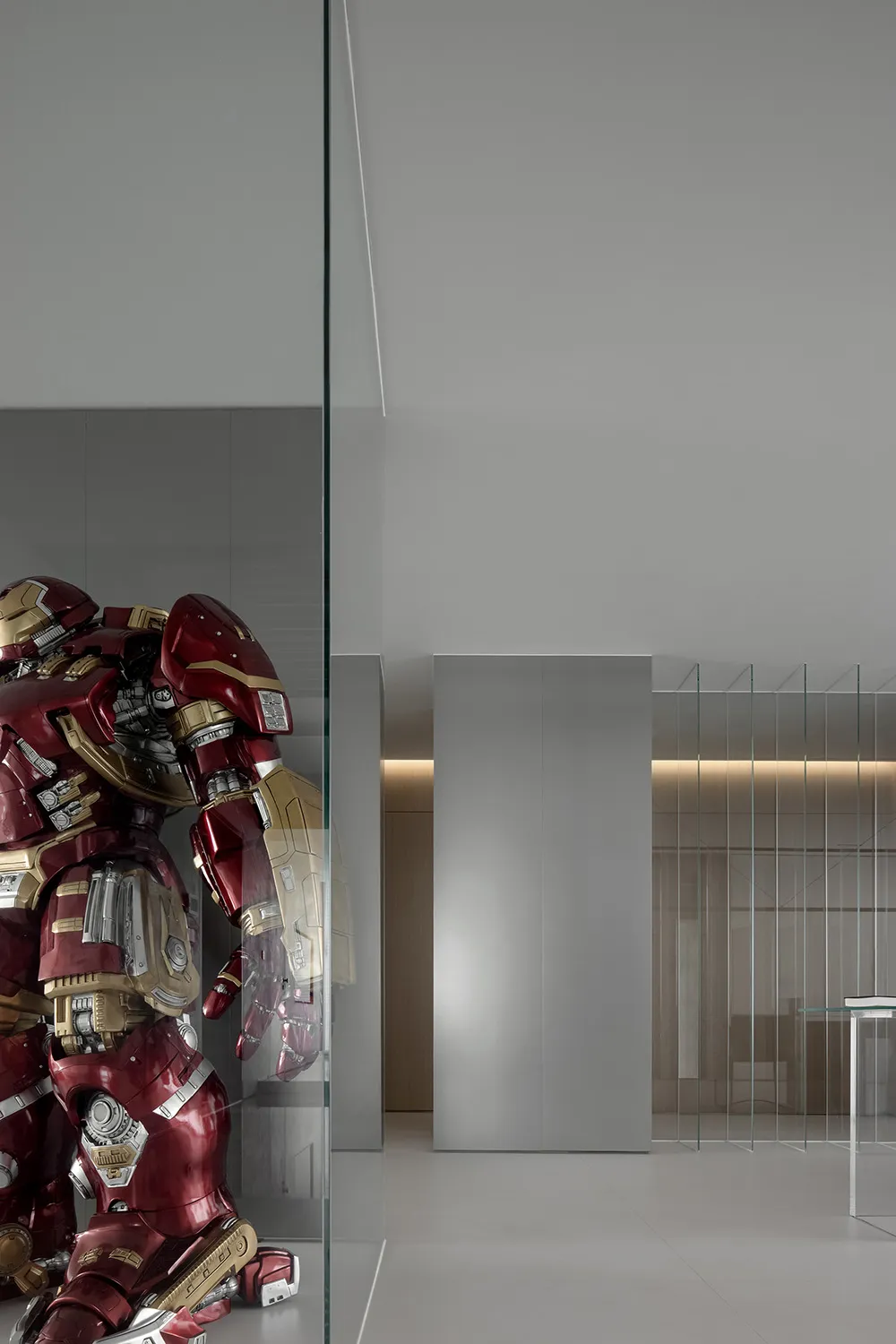 A minimalist interior with a metallic Hulkbuster sculpture.