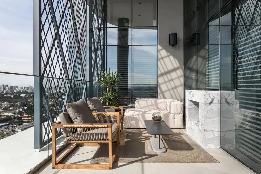 Contemporary balcony featuring wooden seating and glass wall.