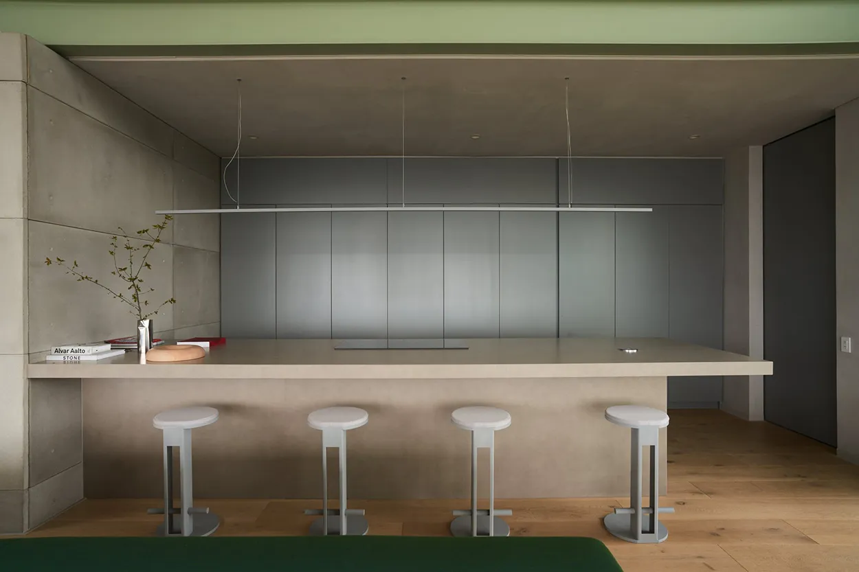 Modern kitchen with concrete island and stools