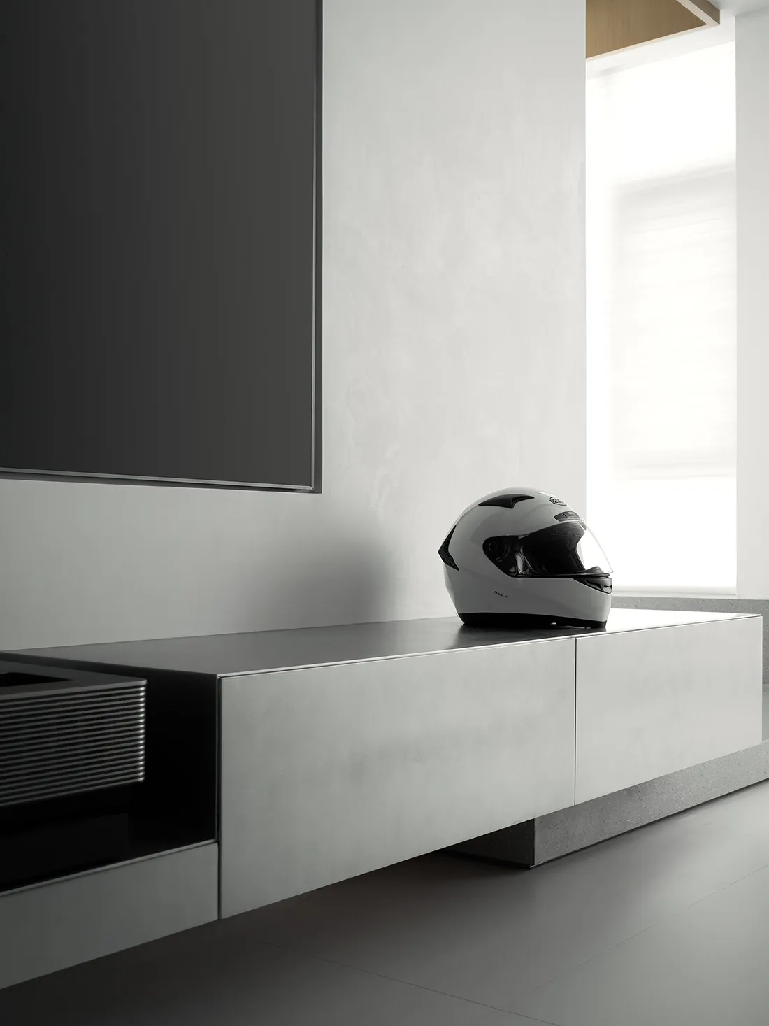 A sleek, minimalist living room with a concrete finish.