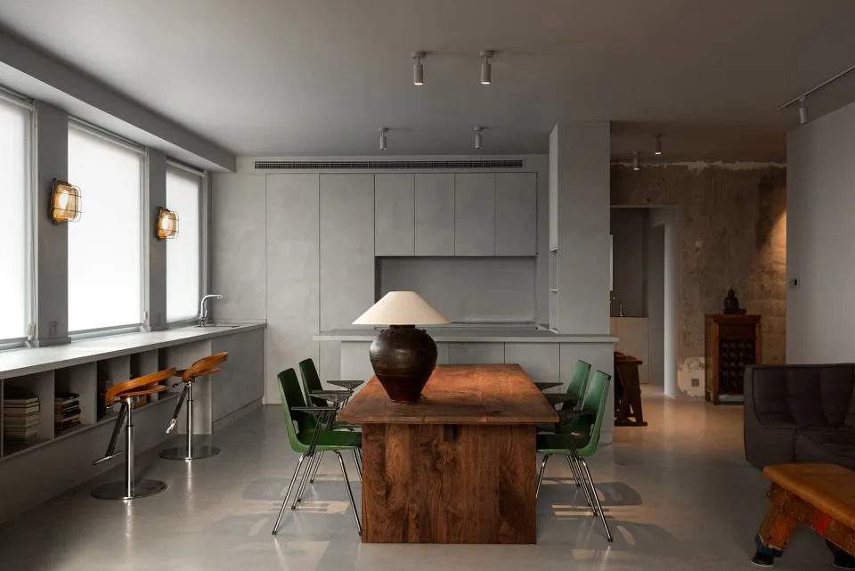 An industrial-style residential kitchen with a concrete and wooden theme.