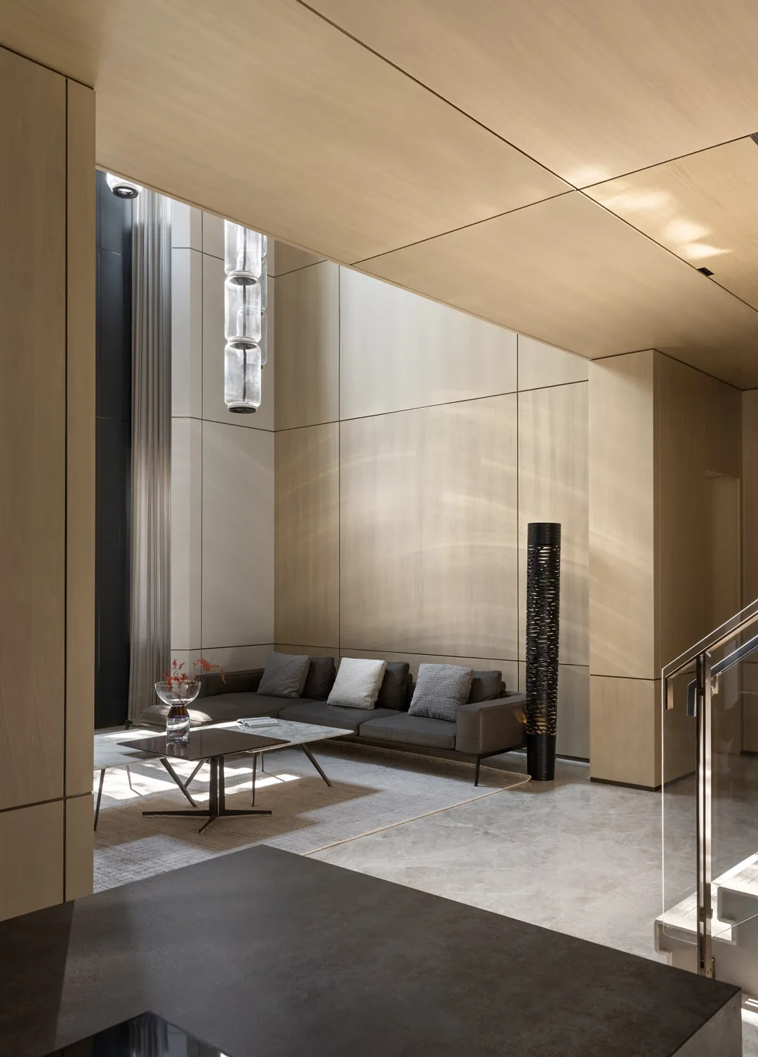 A modern minimalist living room featuring concrete walls, furniture, and floor.