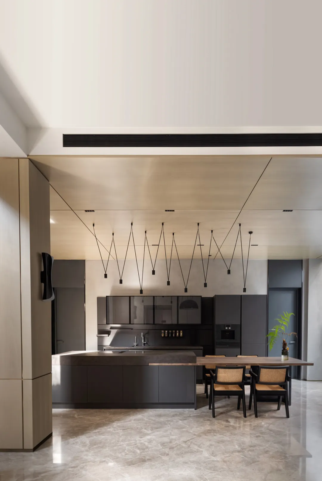 A modern kitchen featuring metallic cabinets and a concrete countertop.