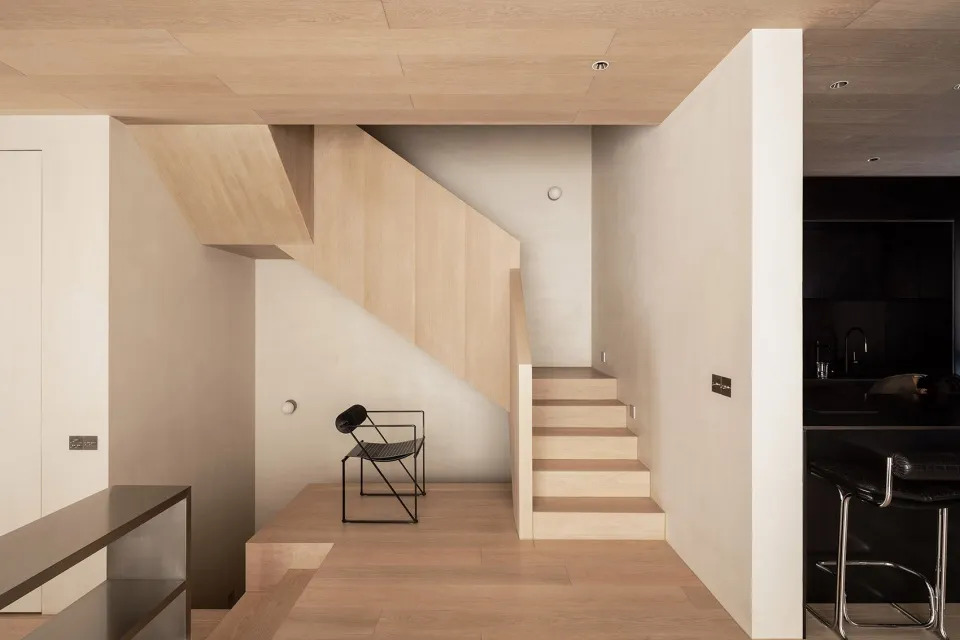 A modern residential staircase with wooden treads.