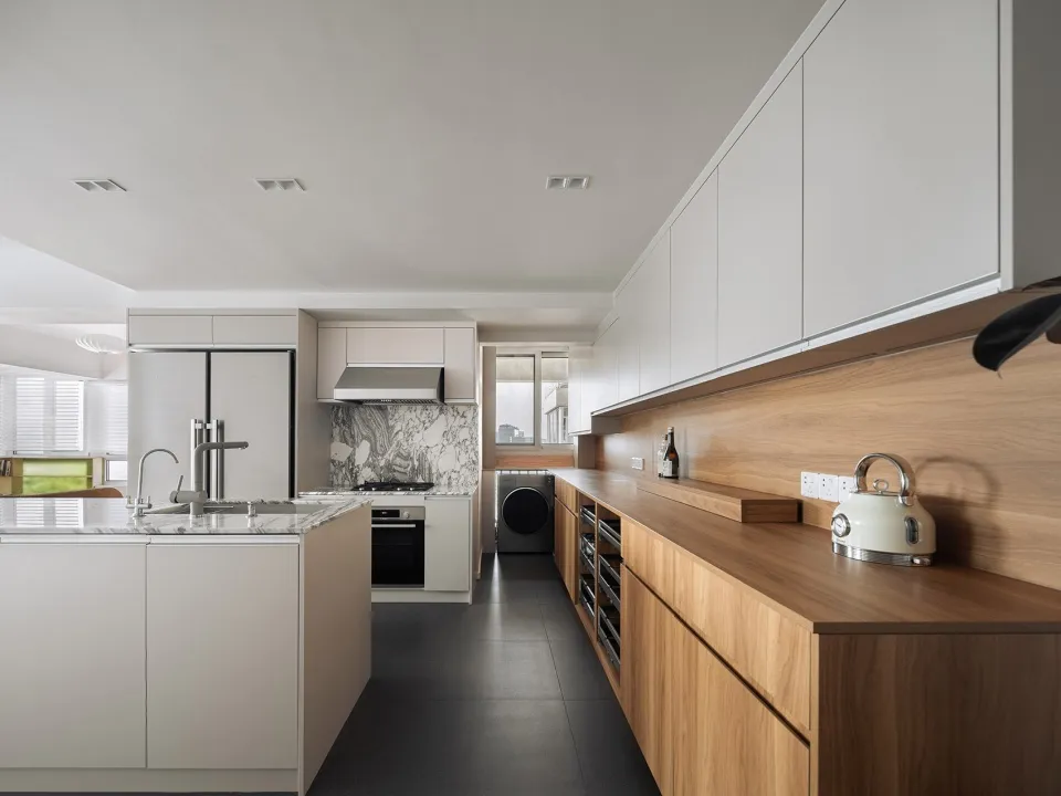 Modern kitchen featuring a marble backsplash and wooden countertops.