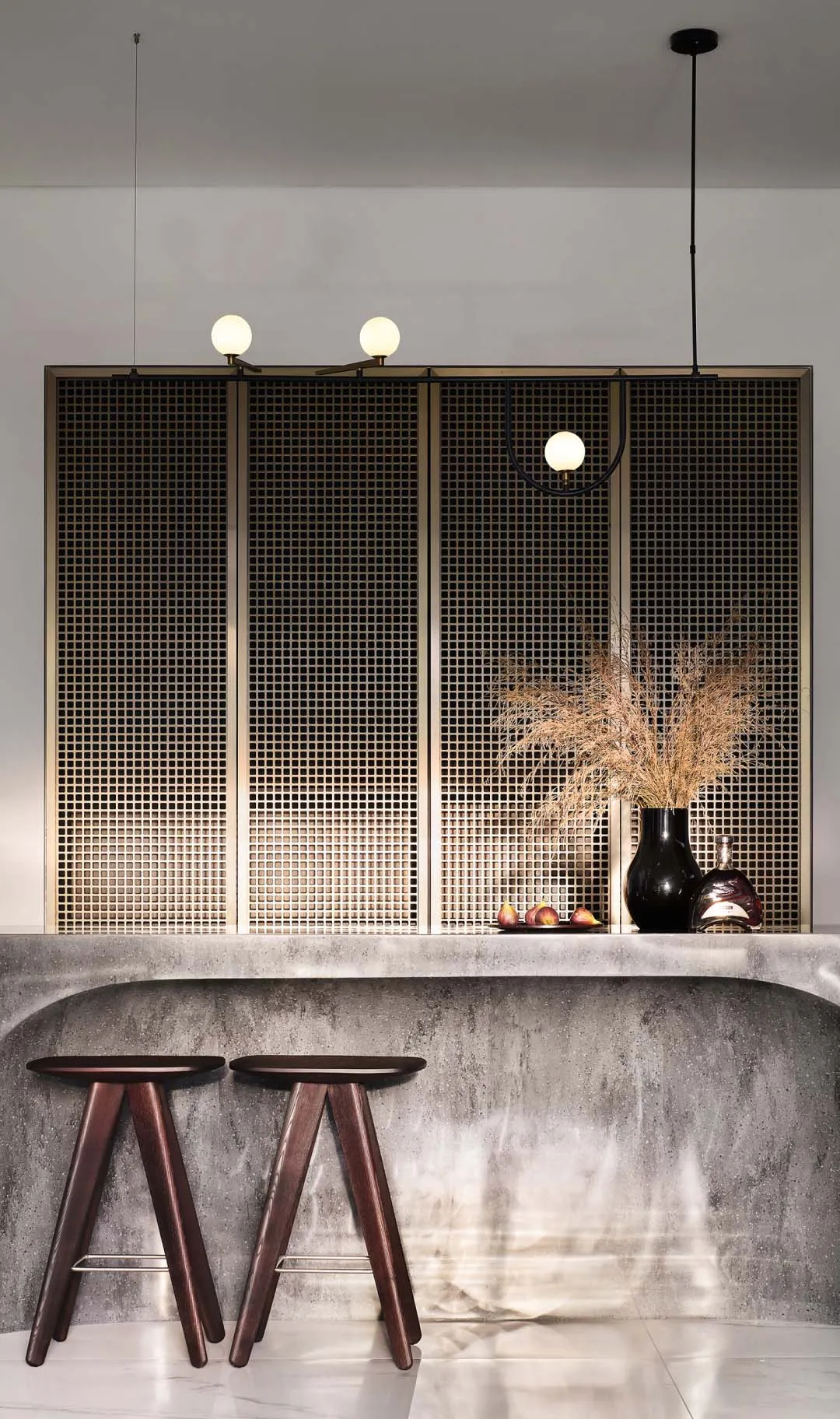 Modern minimalist bar with concrete countertop and metal stools.