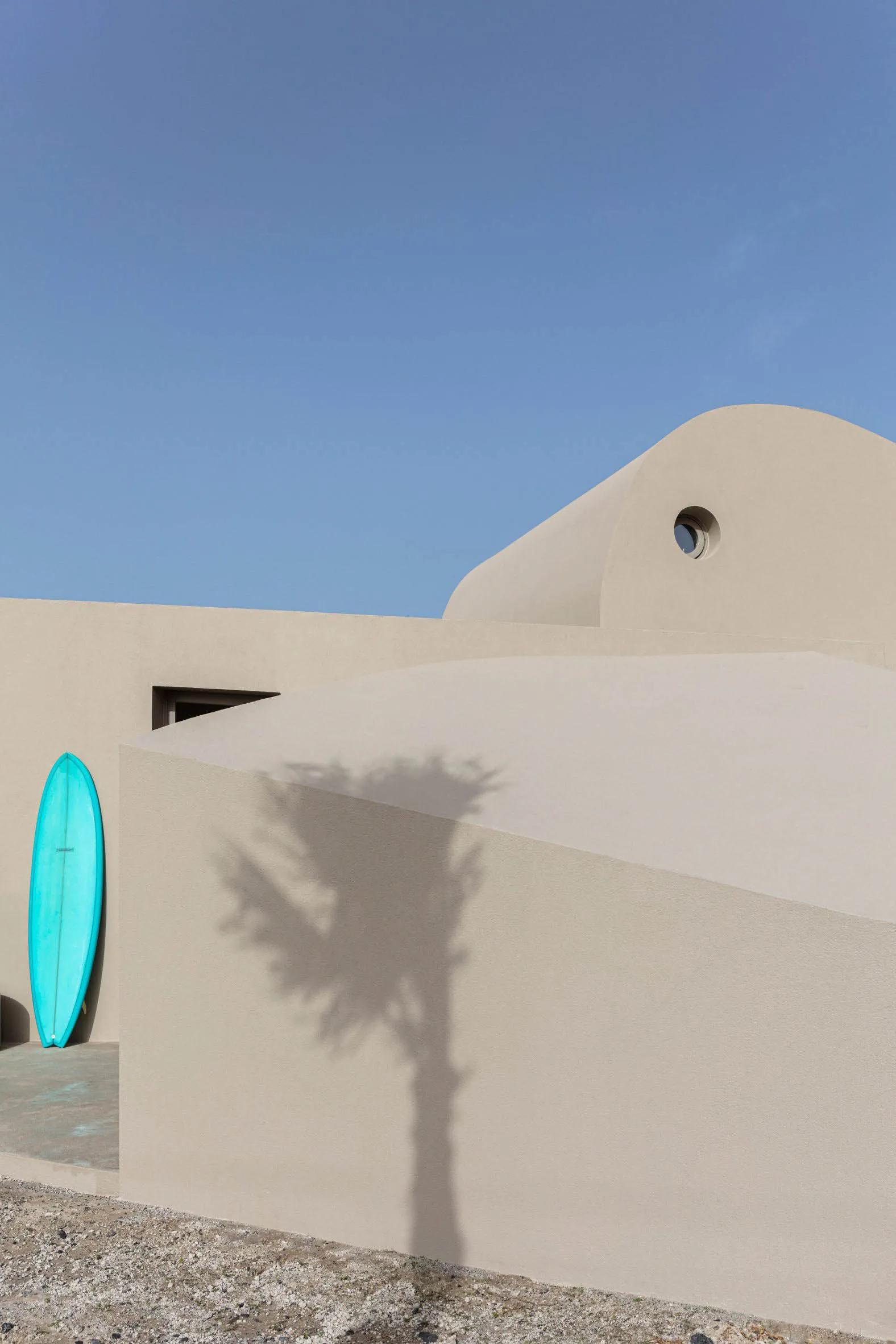 Modern minimalist house with light-colored sandstone exterior.