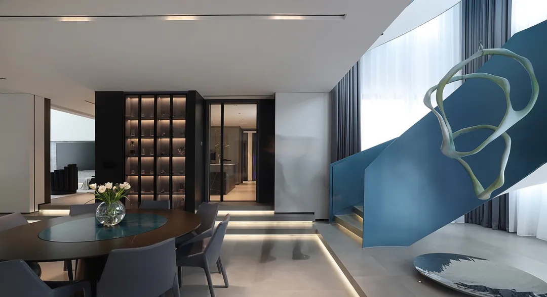 Modern dining room featuring glass walls and concrete floors.