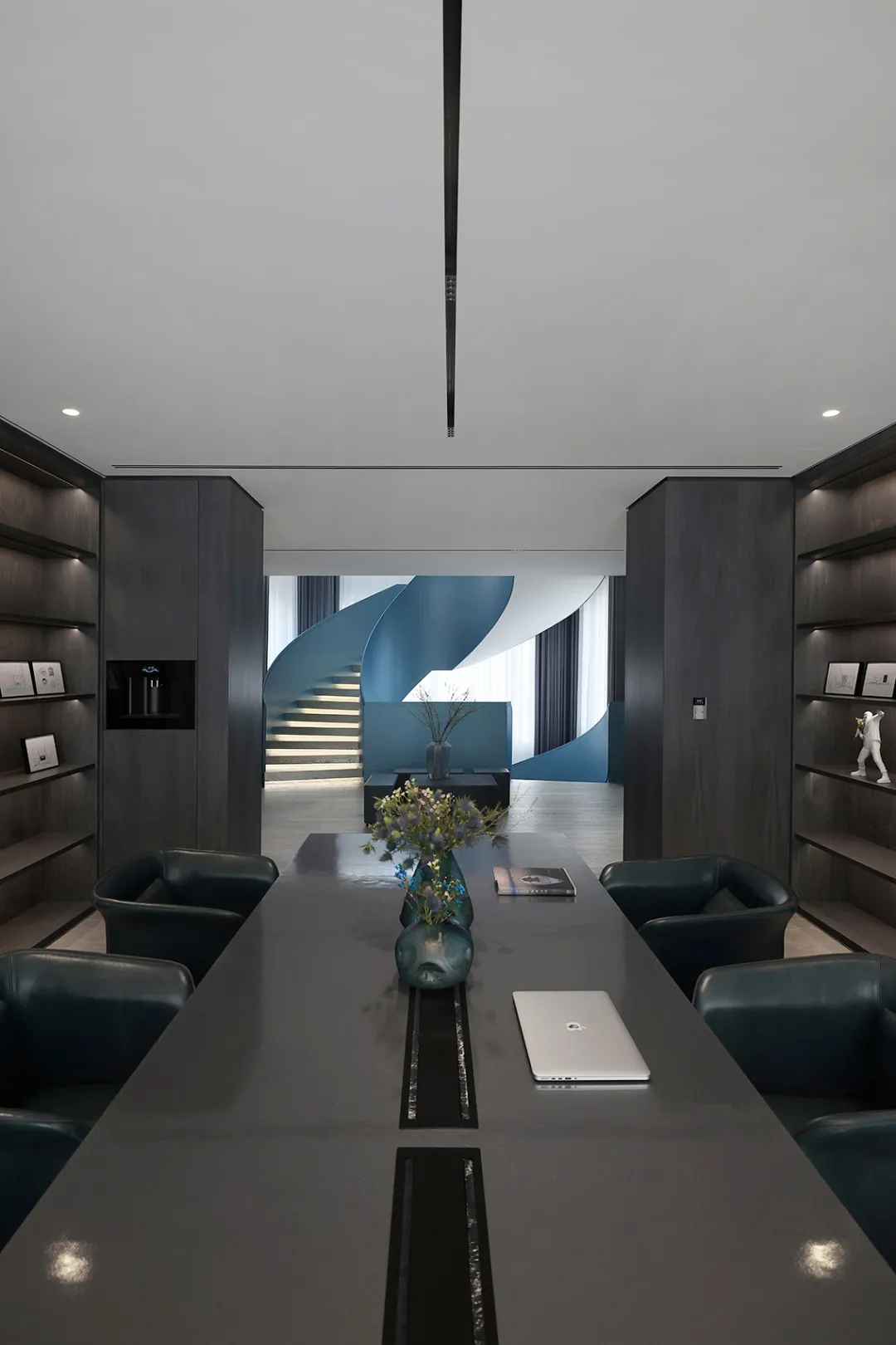 A modern office interior featuring blue metallic accents and black metallic furniture.