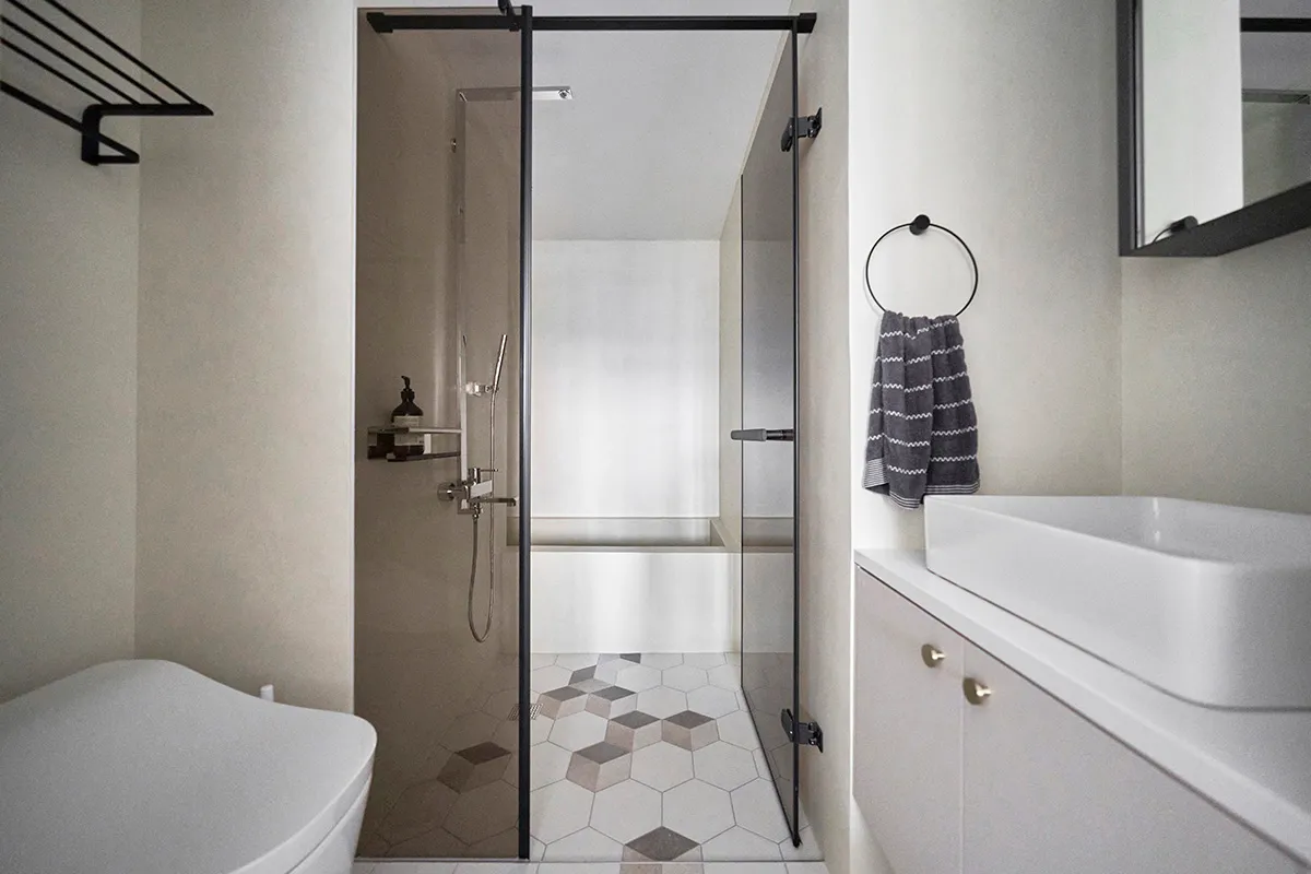 Modern bathroom interior with neutral-toned tiles and minimalist design.