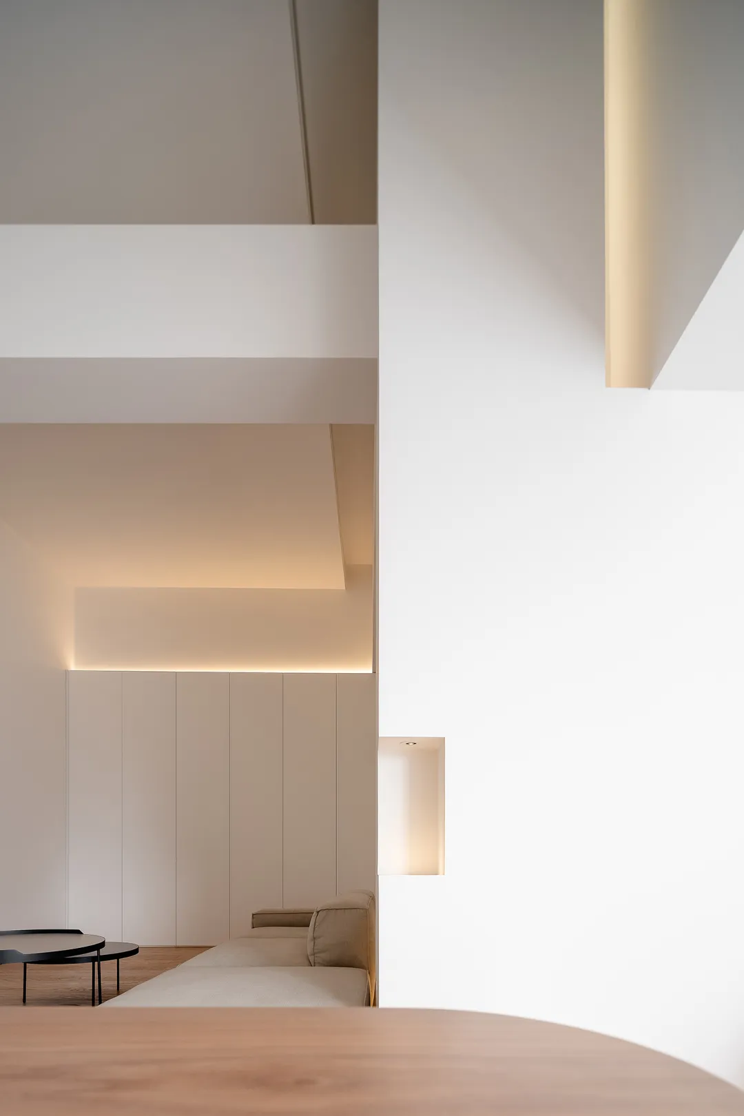 A minimalist living space with neutral-colored walls and furniture.