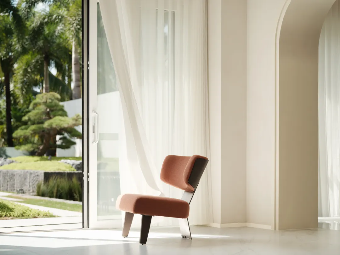 A modern living room featuring a textured fabric chair.