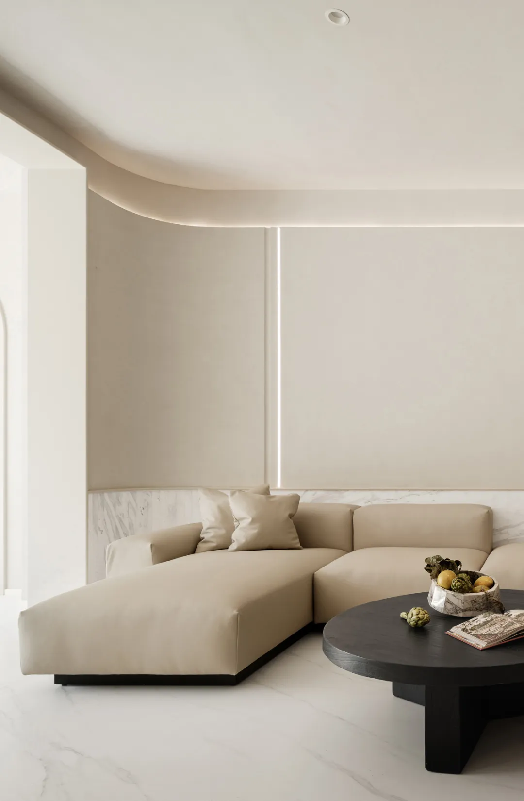 Modern living room with neutral-toned leather furniture and a minimalist design