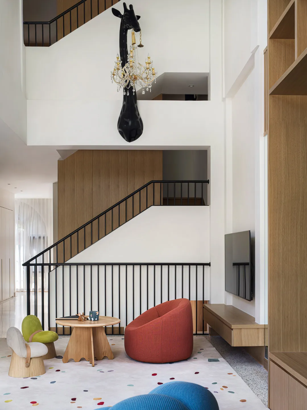 Modern residential living room featuring wooden furniture and colorful accents