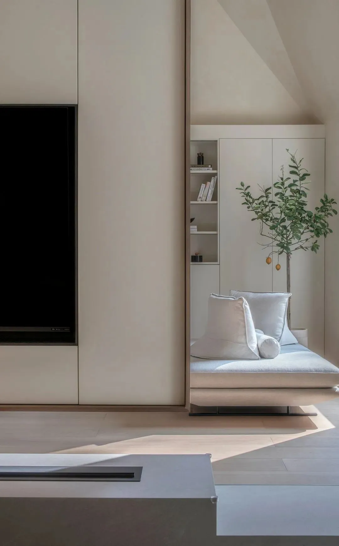 A minimalist living room with a sofa and a bookshelf