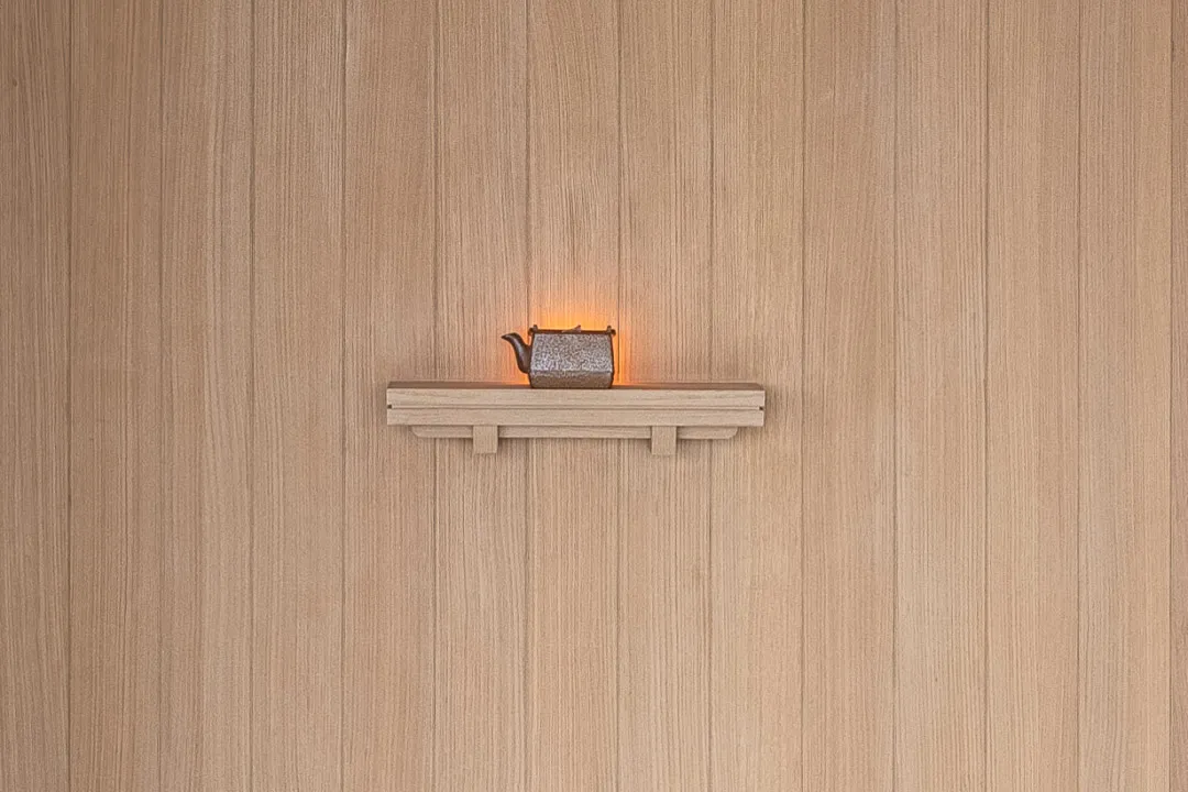 A minimalist ceramic teapot decoration on a wall shelf.