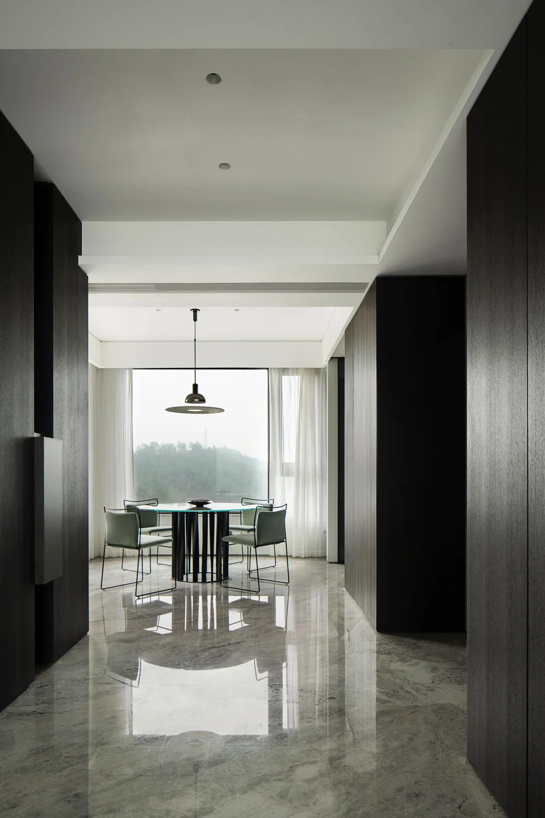A modern interior space featuring a glass table and chairs