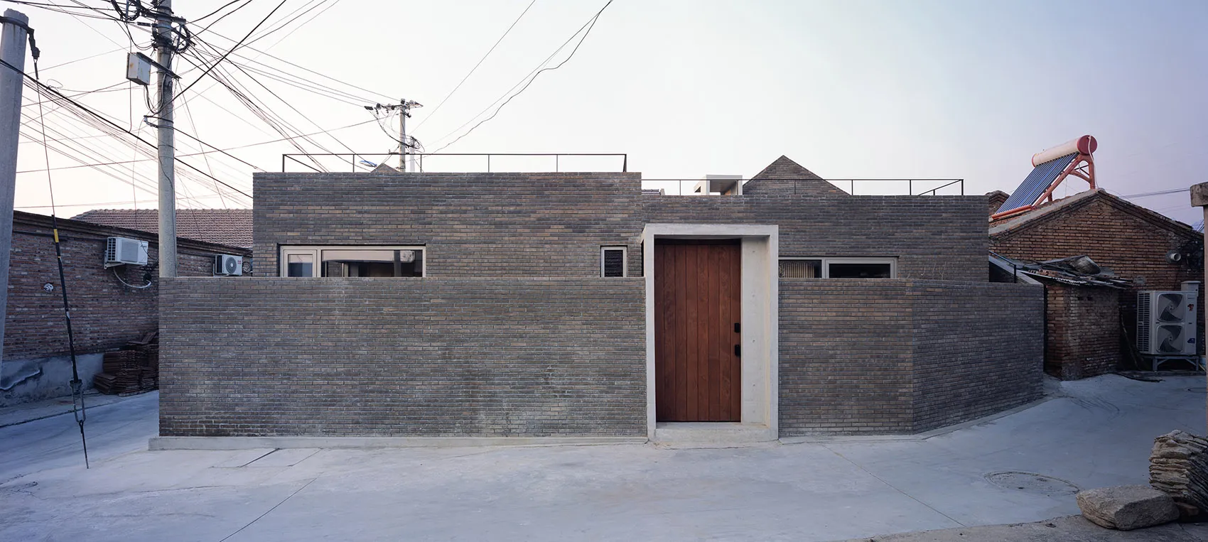 Modern minimalist building exterior made of brick, featuring clean lines and simple design.