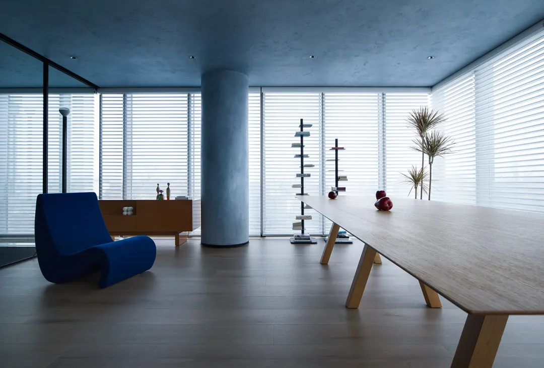 A modern minimalist live-work space with wood, glass, and concrete materials.