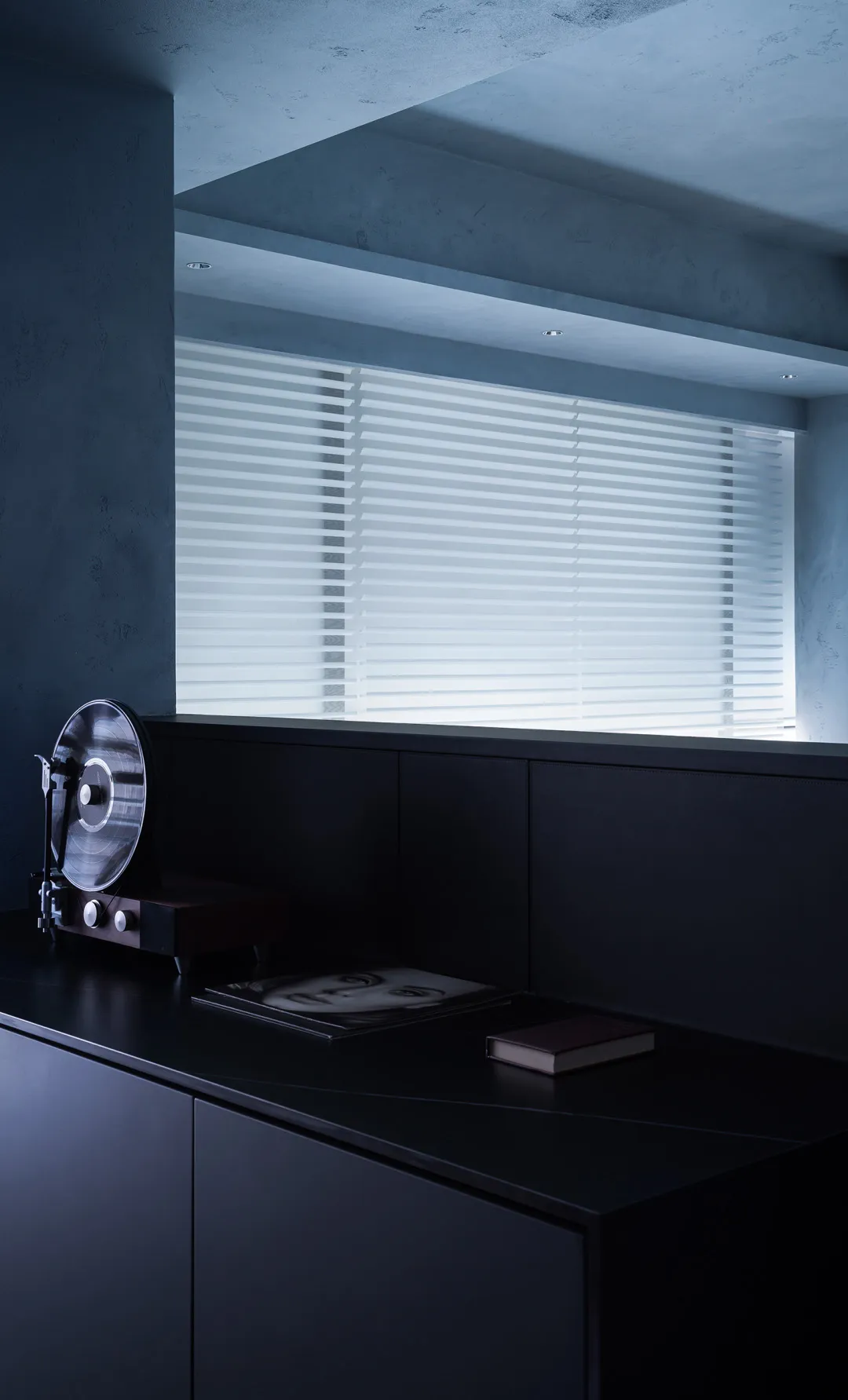 A minimalistic, industrial-style black interior moodboard featuring a record player, a record, and a book on a window sill wi