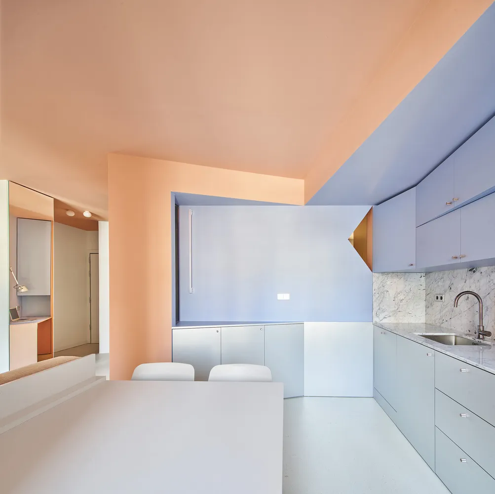 A modern minimalist kitchen with concrete finishes and a minimalist design.