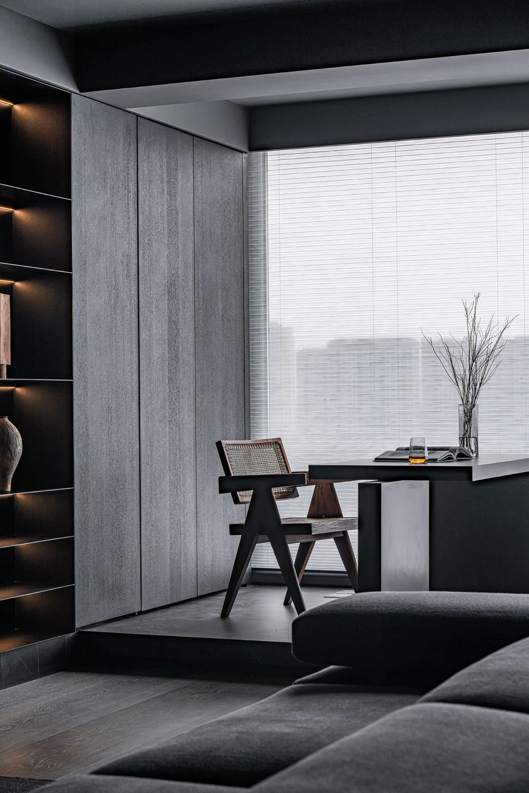 A minimalist apartment featuring wooden furniture and glass elements.