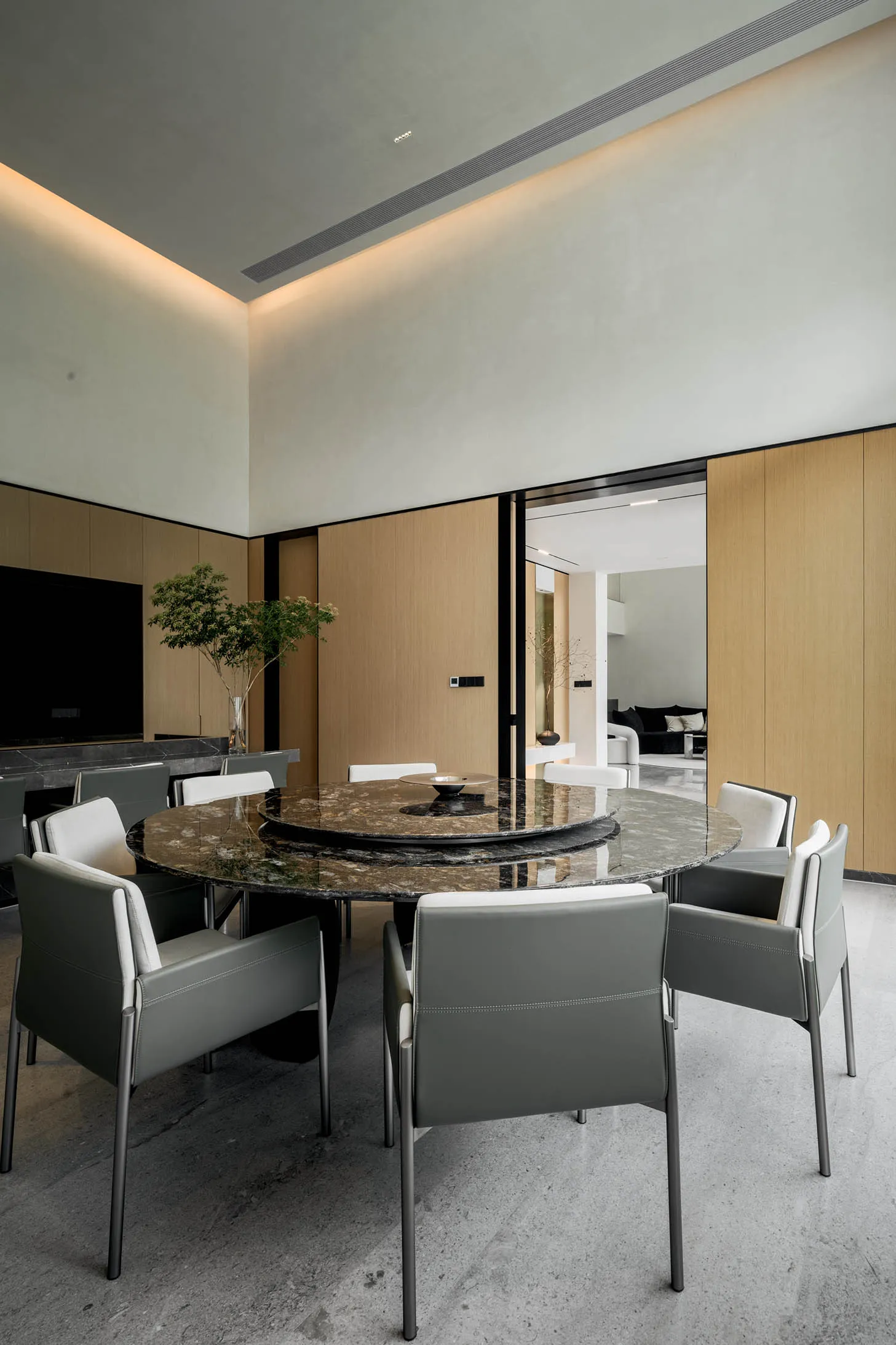 Modern dining room featuring a granite table and minimalist design.