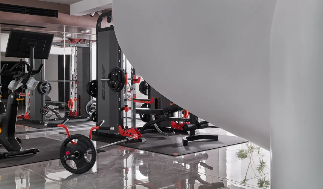 A modern gym interior with industrial design elements and metal equipment.