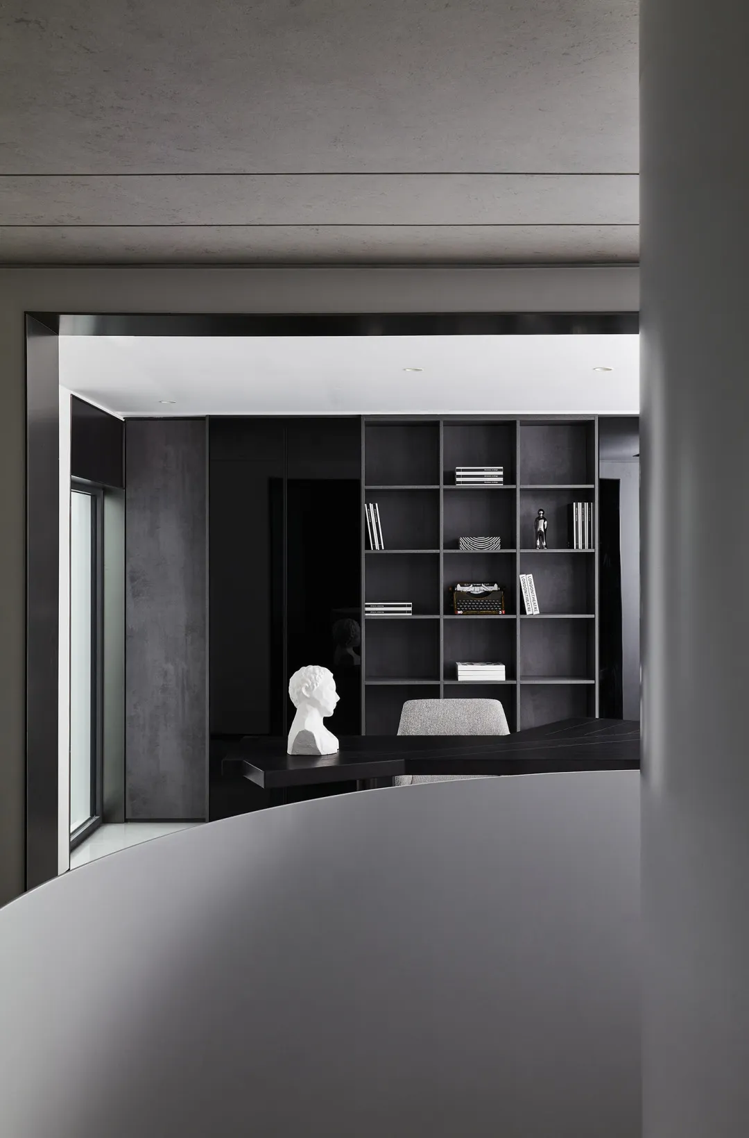 Modern office space with concrete, glass, and metal finishes.
