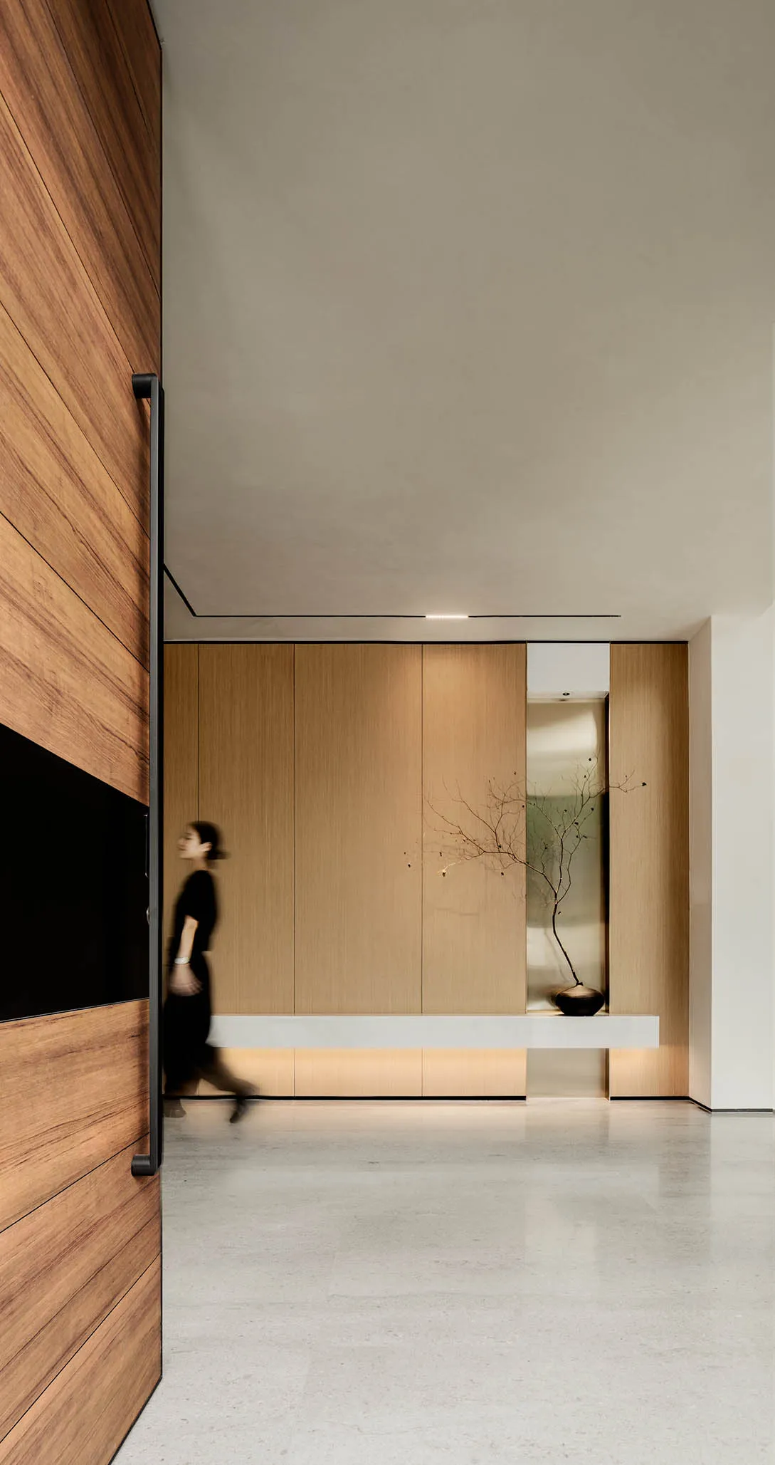 A modern office space featuring wood, glass, and concrete materials.
