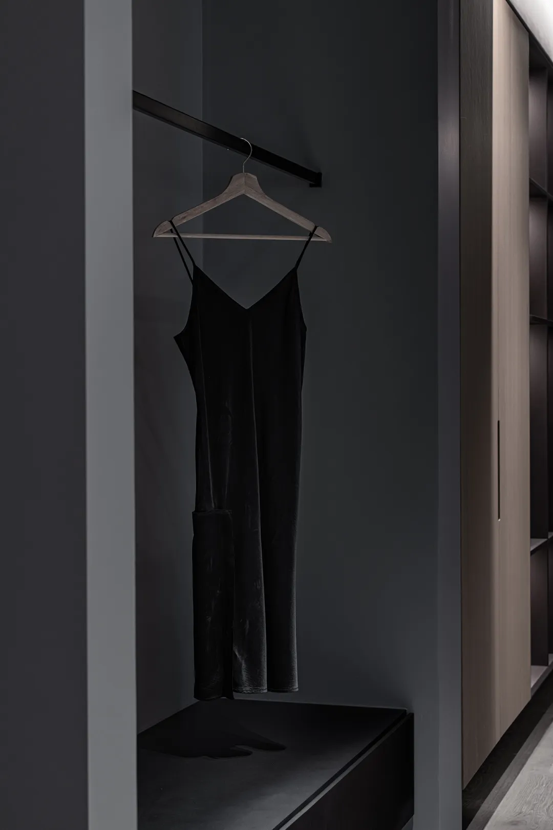 A modern clothing display featuring a black hanging garment.