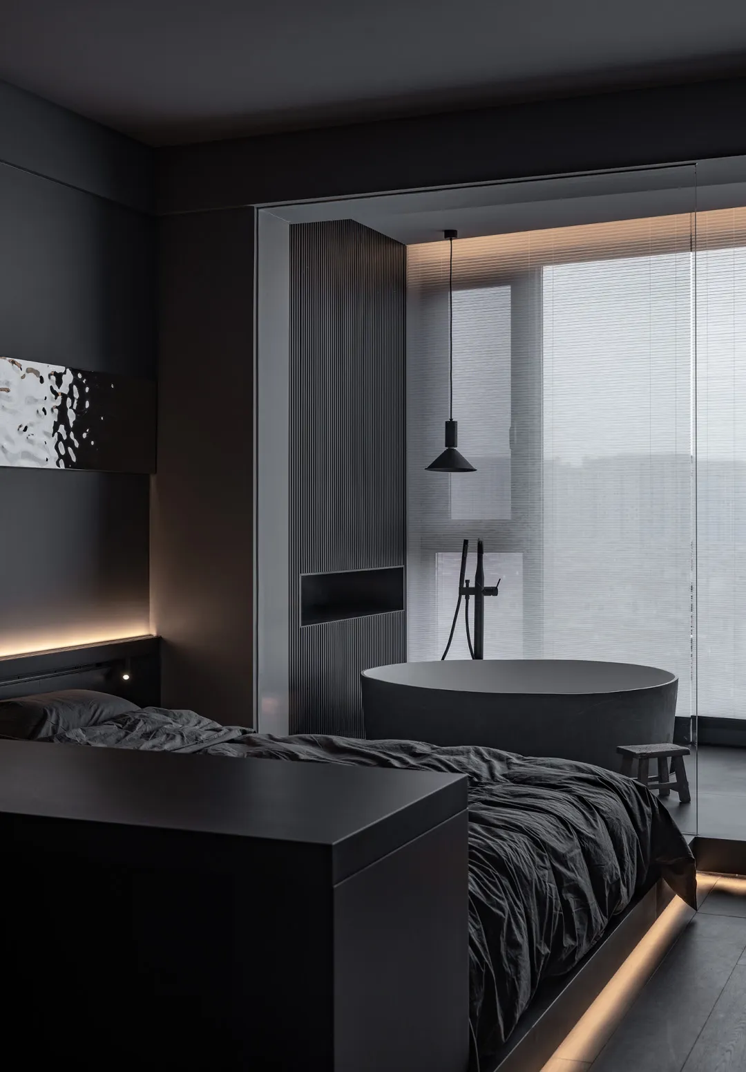 A modern minimalist bedroom with a concrete bed and a large window.