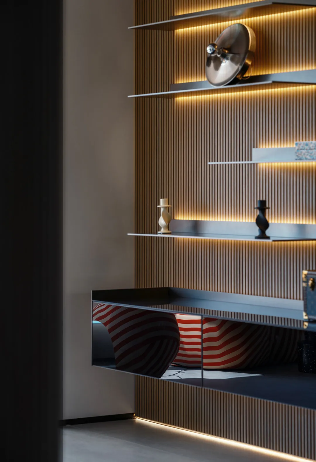 Modern shelf display with metallic floating shelves and lighting