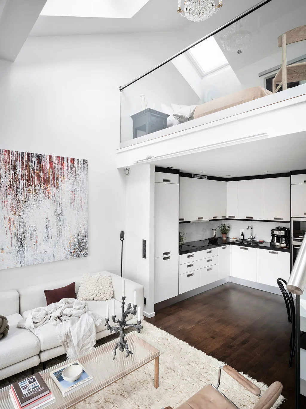 A modern minimalist living room with white furniture and a cozy atmosphere.