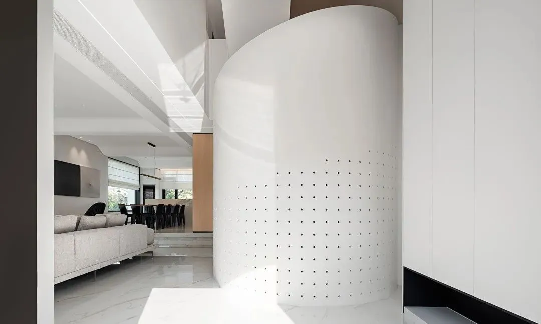 A modern living room with concrete elements and a minimalist design.