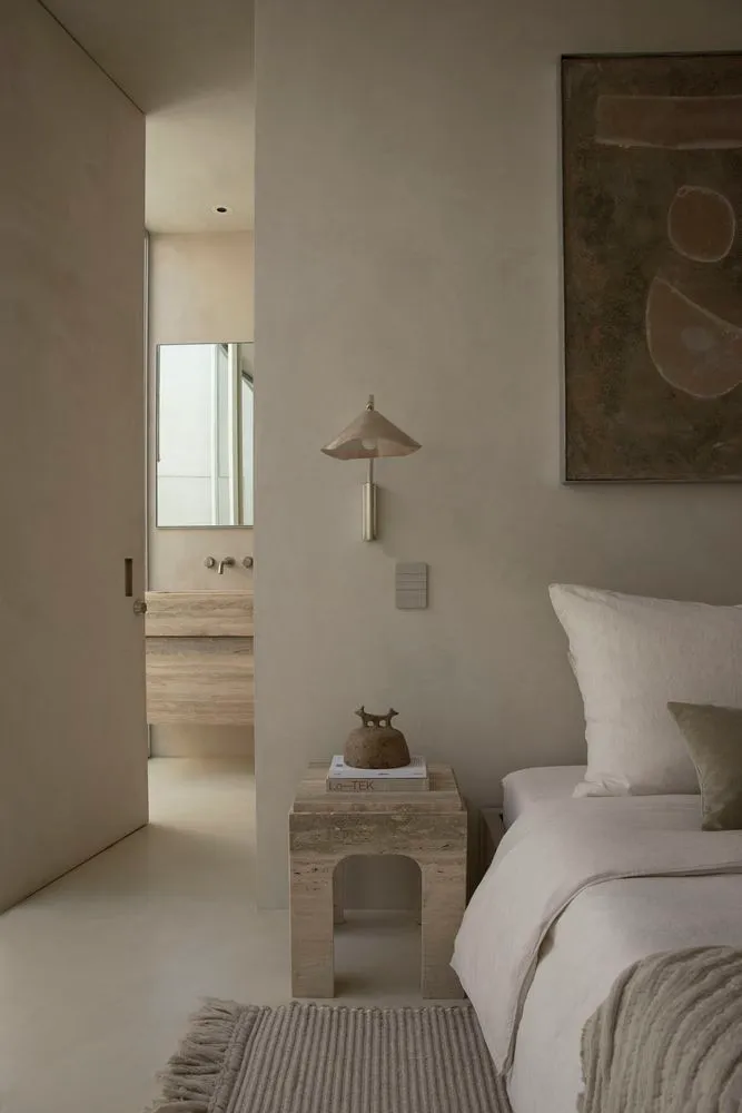 Minimalist bedroom interior design with concrete materials.