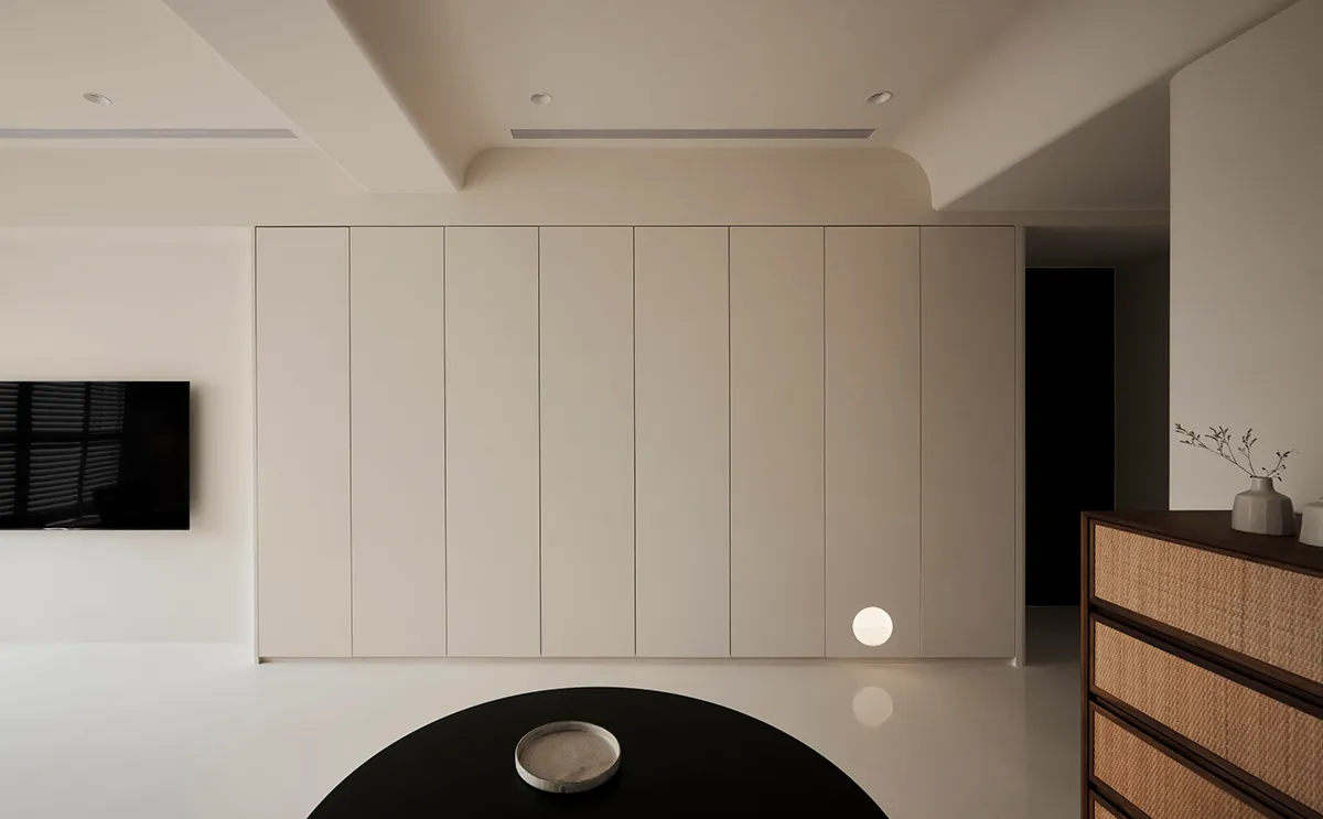 A modern minimalist white interior with sleek, flat surfaces and clean lines.