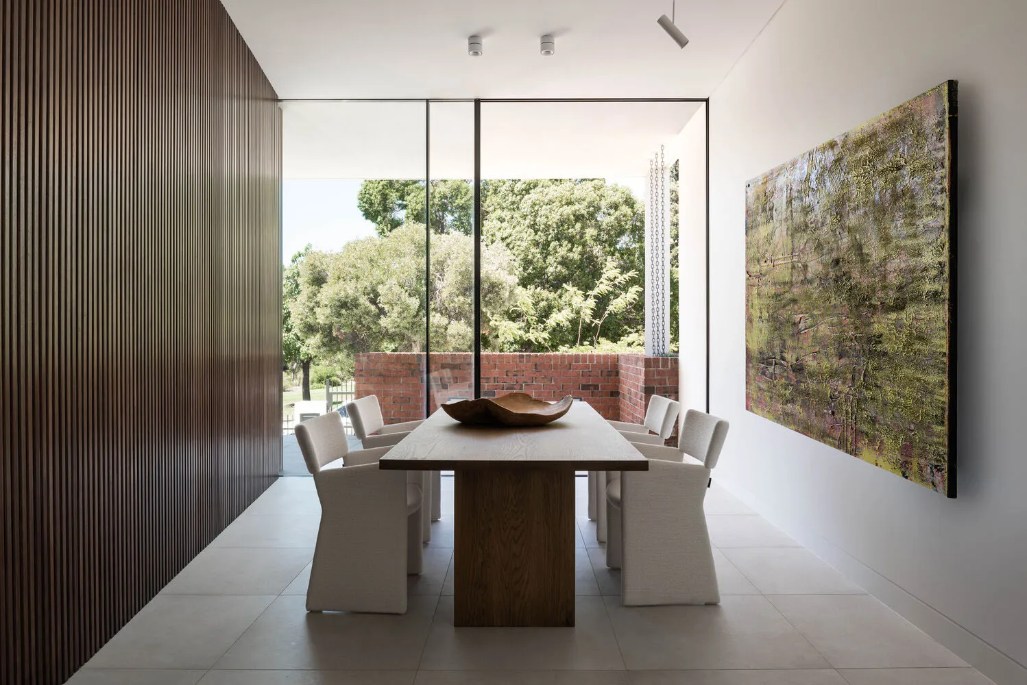 Modern dining room featuring a wooden table and fabric chairs