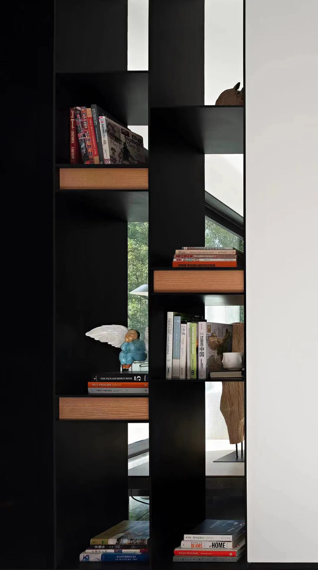 A modern library featuring black wooden shelves with metal accents.