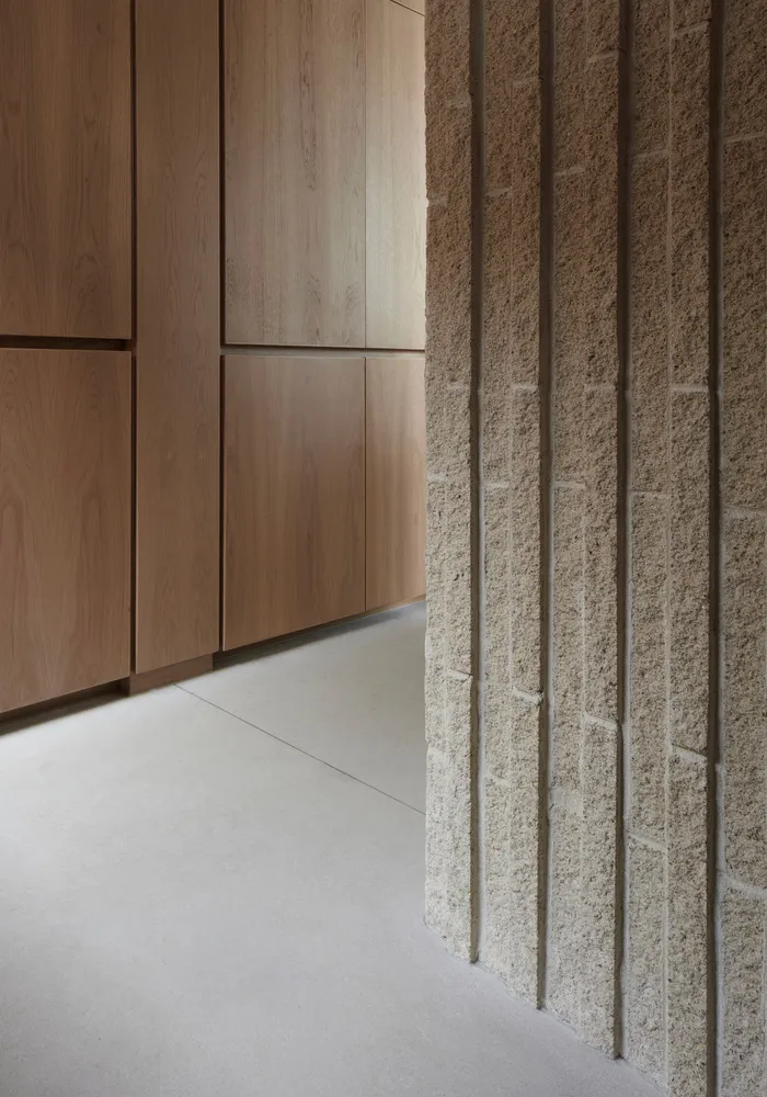 A modern interior space featuring concrete tiles on a wall and floor.
