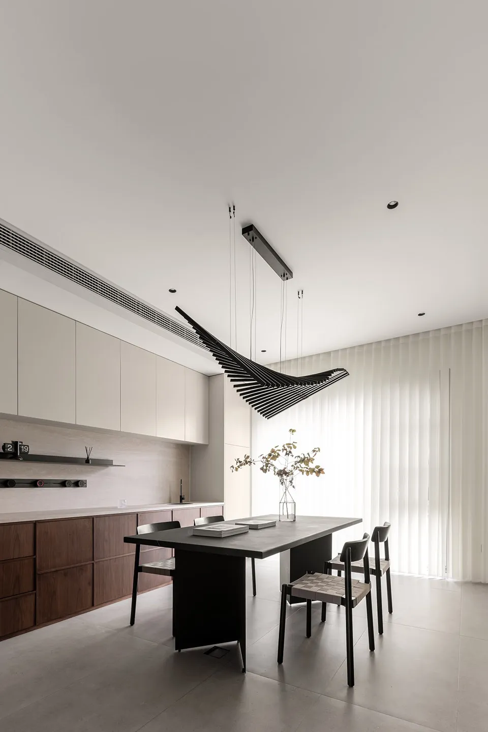 Modern kitchen interior featuring minimalist design with concrete accents. Includes sleek countertops, sleek cabinets, and ge