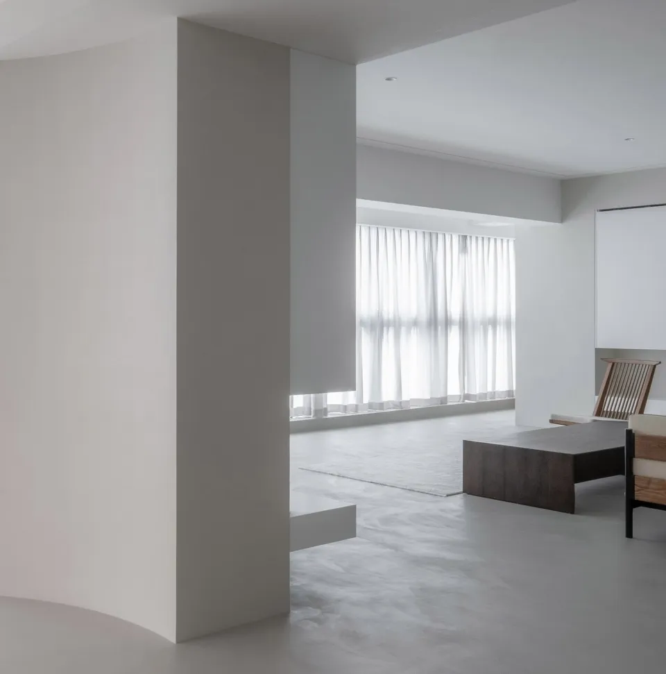 A minimalist white concrete living room