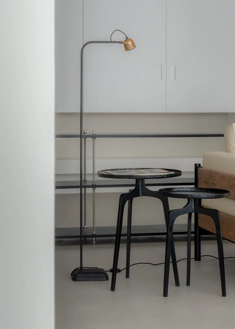 A modern living space featuring a metal floor lamp and a marble coffee table.