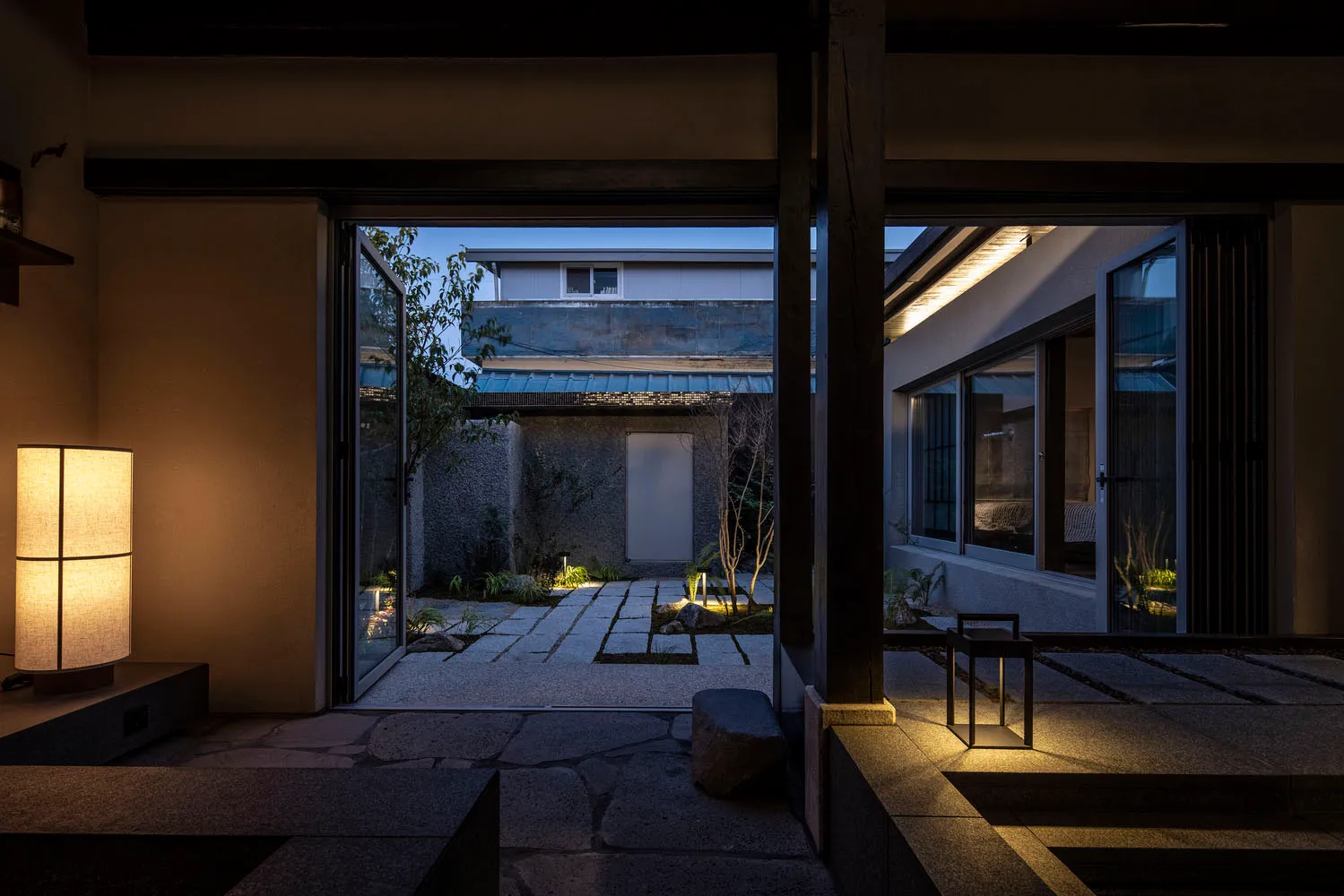 Minimalist residential interior with concrete, glass, and metal elements.