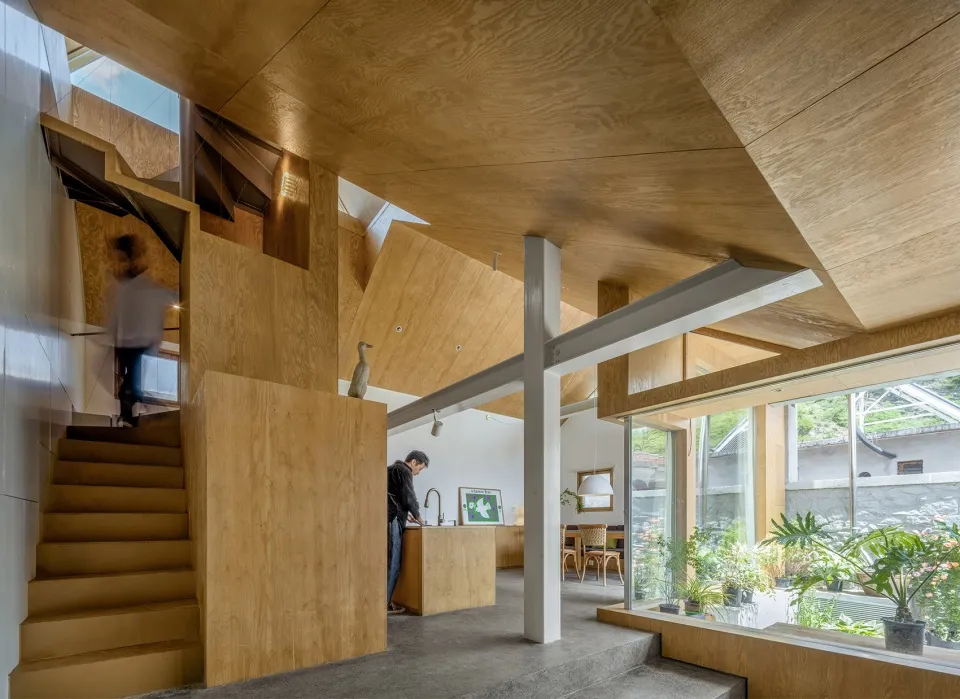 A modern living space featuring wood-ply walls and open-plan design.